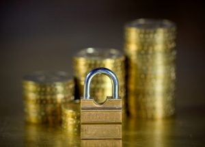 Padlock in front of coins