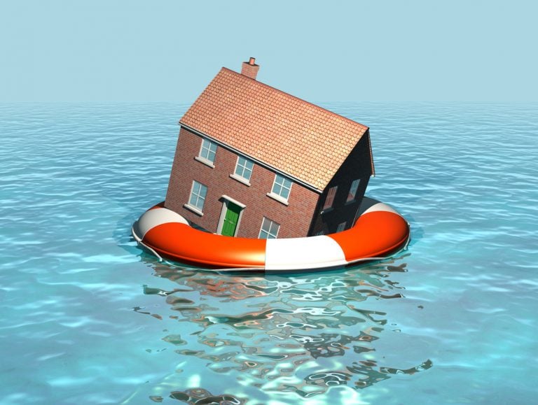 House resting on a life ring to illustrate flood-damaged rental property risk