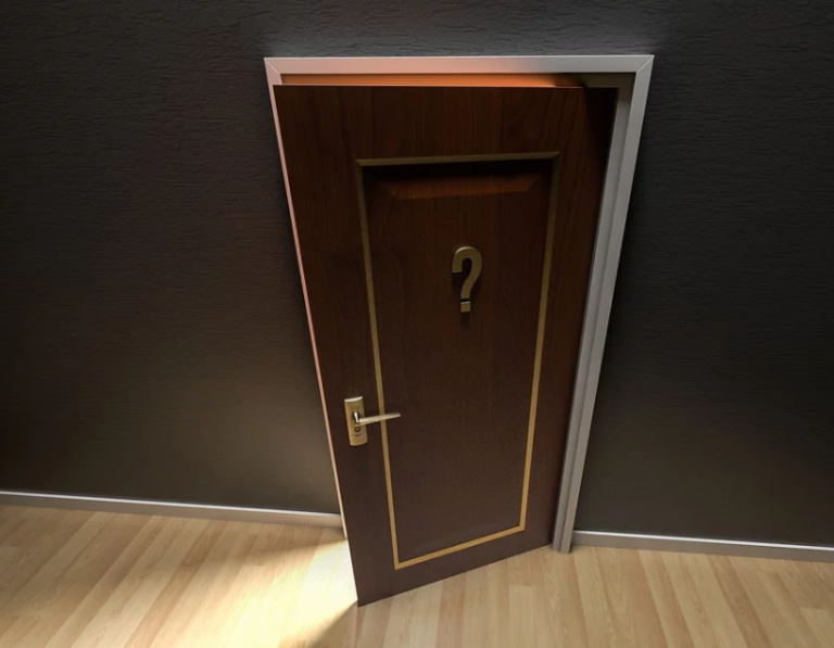 Slightly open wooden door with a question mark symbol, representing uncertainty about housing policy.