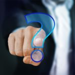 Business person pointing at a glowing question mark, symbolising uncertainty about leaseholder rights