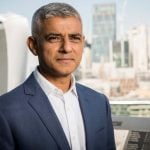 Sadiq Khan in London with city skyline in the background.