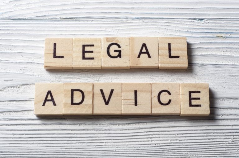 Wooden tiles spelling “legal advice” on a white textured surface, illustrating guidance on landlord–management company disputes.