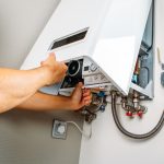 Engineer performing maintenance on a home boiler system to ensure safe winter operation