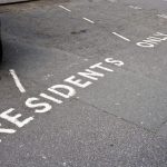 Residents-only parking bay markings on a shared residential car park