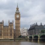 Houses of Parliament and Big Ben overlooking the River Thames during overcast weather, supporting article on UK housing standards