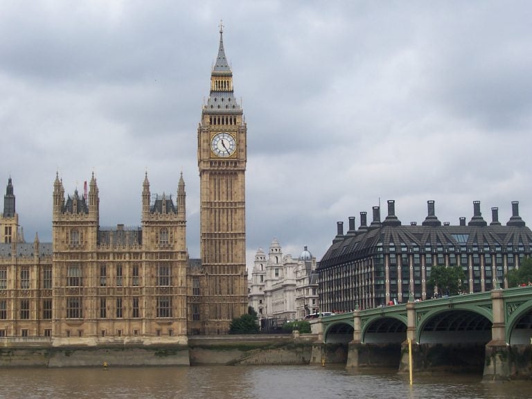 Houses of Parliament and Big Ben overlooking the River Thames during overcast weather, supporting article on UK housing standards