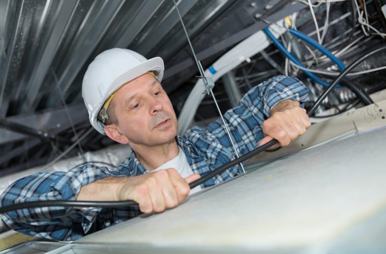 Electrician rewiring a rented flat property118.com