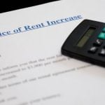 Rent increase notice with calculator on top of tenancy letter