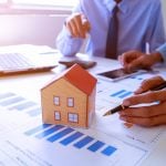 man and laptop and graphs Property market predictions property118.com