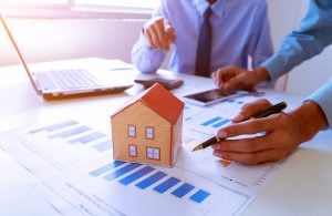 man and laptop and graphs Property market predictions property118.com