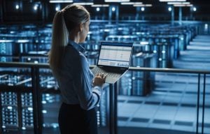 woman looking at a laptop in a data centre property118.com