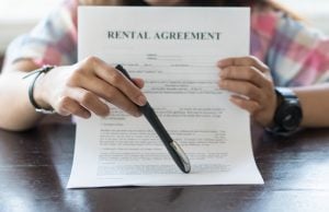 landlord holding tenancy agreement how to best increase rents property118.com