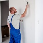 man painting a mould party wall property118.com