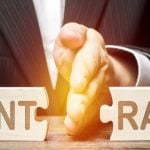 Hand separating wooden puzzle pieces symbolising a broken contract in an eviction context