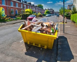 Pic of skip filled with rubbish alcoholic tenant landlord property118.com