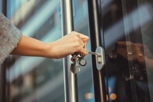 Pic of woman unlocking a tenants door locks changed landlord property118.com