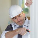 Pic of man fitting double glazing landlord tenant epc cost property118