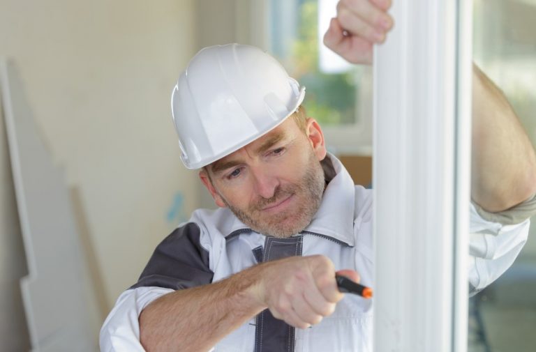 Pic of man fitting double glazing landlord tenant epc cost property118