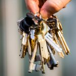 A hand holding a bunch of keys