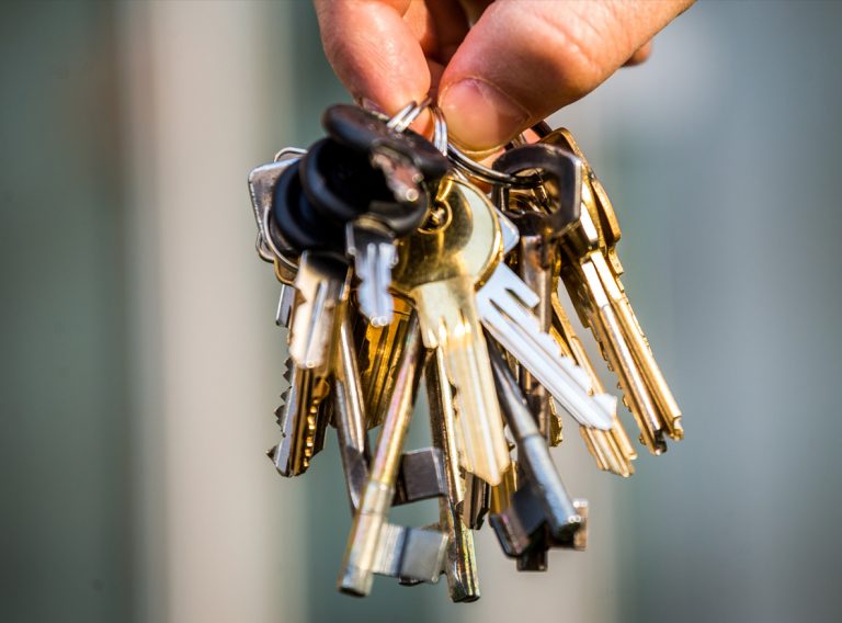 A hand holding a bunch of keys