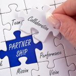 Puzzle pieces highlighting partnership values like collaboration, trust, and goals