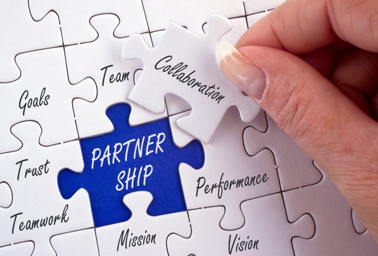 Puzzle pieces highlighting partnership values like collaboration, trust, and goals
