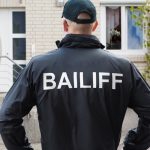 Pic of bailiff outside a tenants house arrears landlords property118