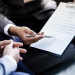 Landlord reviewing a property management contract before signing termination terms.