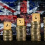 Rates spelled out on stacked coins with UK flag in the background