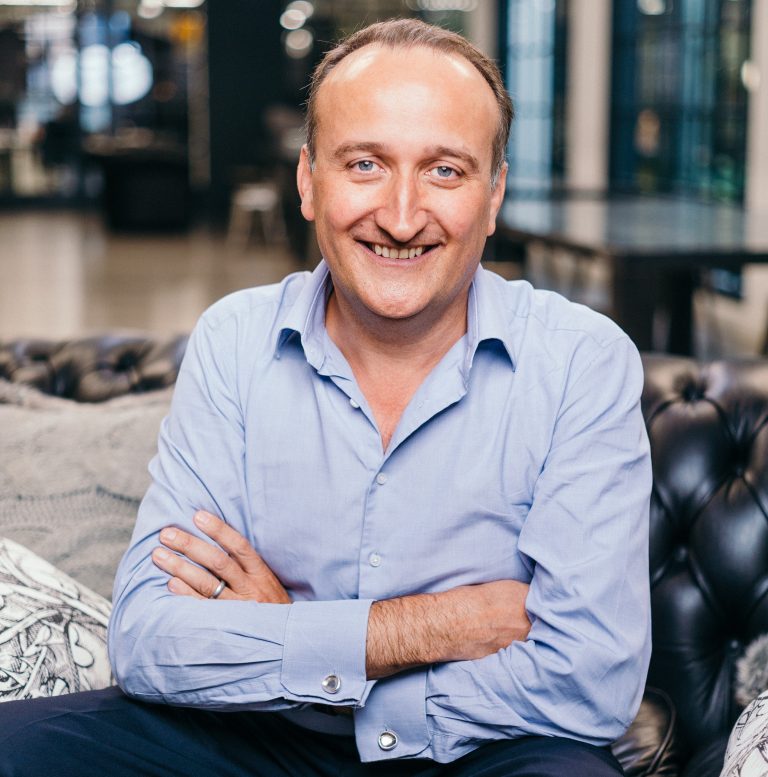 Smiling business professional sitting confidently in a modern office setting