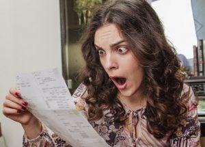 pic of woman landlord looking shocked at a managing agents bill property11