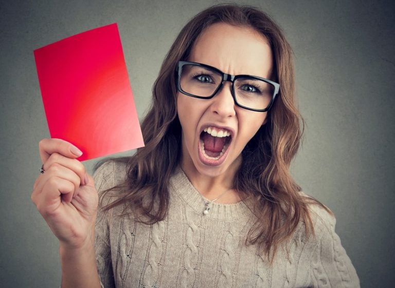 pic of woman holding a red card as a penalty for landlords in the uk property118
