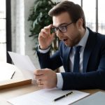 Pic of landlord reading a letter from a letting gent about EPC rules property118