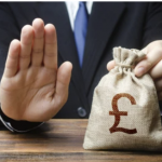 Hand blocking a money bag with a pound symbol, representing refusing a payoff to a lodger