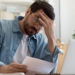 Pic of landlord looking at buildings insurance bill from managing agents property118