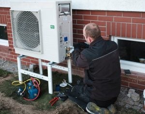 pic of a heat pump being installed cost landlords property118