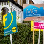 For sale and sold signs outside UK homes amid slowing housing market growth