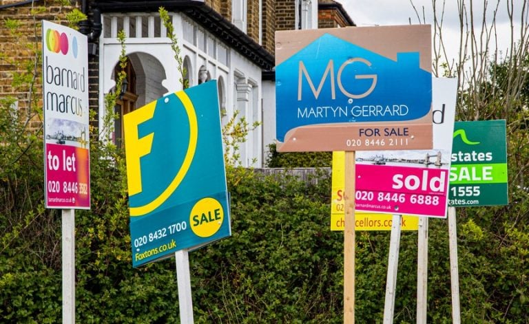 For sale and sold signs outside UK homes amid slowing housing market growth