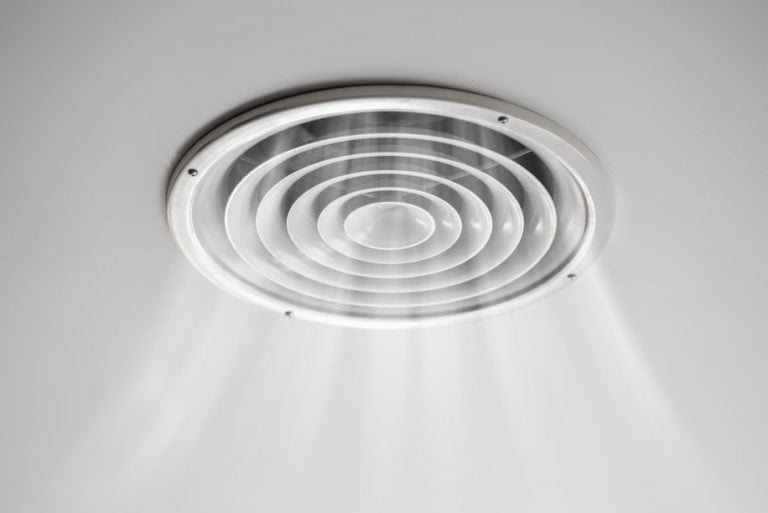 Ceiling-mounted positive input ventilation outlet releasing filtered air