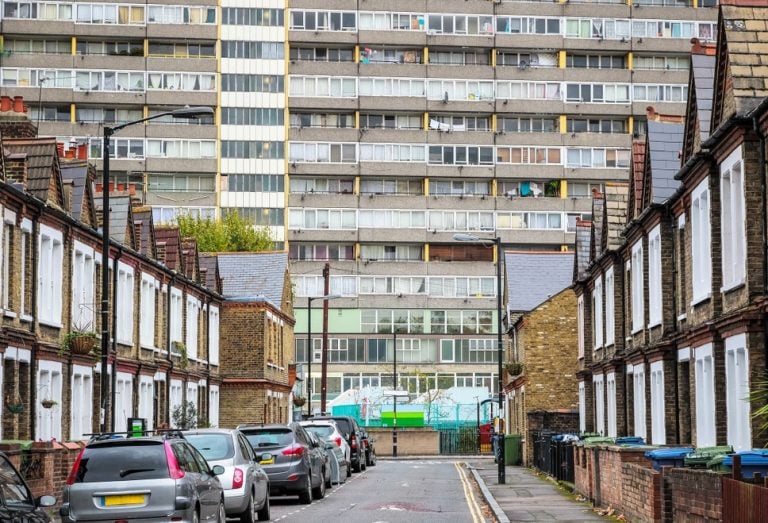 Contrast between traditional terraced houses and a large modern social housing block in an English city