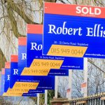 Sold estate agent signs highlighting the UK property market squeeze amid landlord sell-offs.