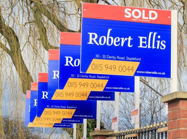 Sold estate agent signs highlighting the UK property market squeeze amid landlord sell-offs.