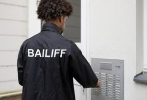pic of bailiff gaining entrance to a rented home to evict property118