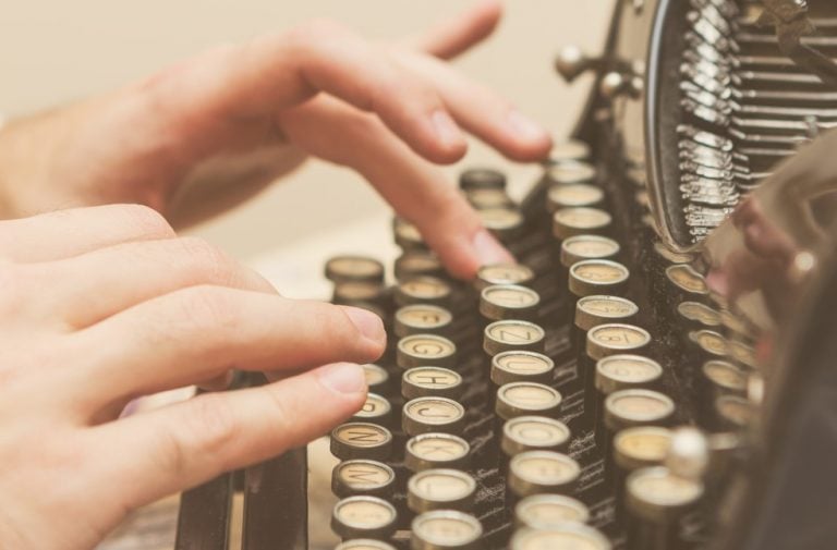 pic of woman typing on old typewriter county court typing up a judge's order property118