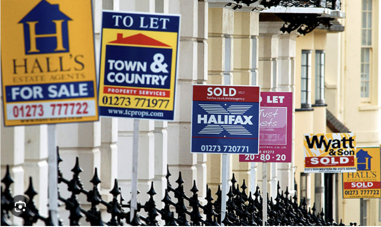 Property for sale and sold signs outside UK houses showing active housing market