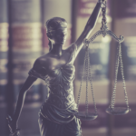 Lady Justice statue with scales symbolizing law and fairness in eviction debate