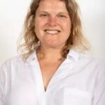 Councillor Grace Williams smiling in a white shirt against a plain background