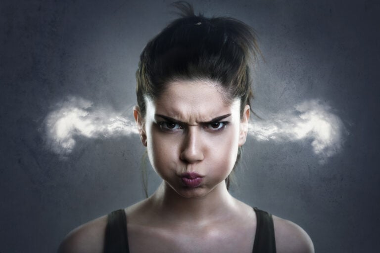 Frustrated woman with steam coming out of her ears, symbolizing anger and stress.