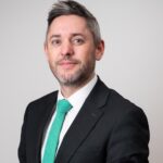 Foxtons lettings director in business suit discussing London rental market trends
