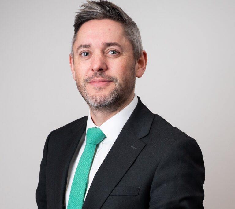 Foxtons lettings director in business suit discussing London rental market trends